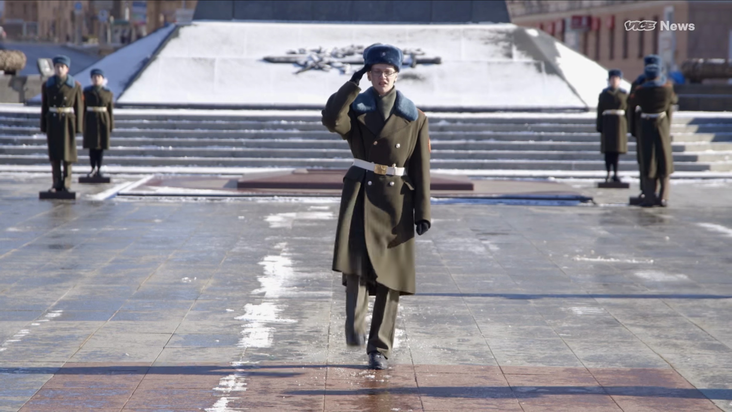 Uniformed guard at a winter memorial during filming for VICE News
