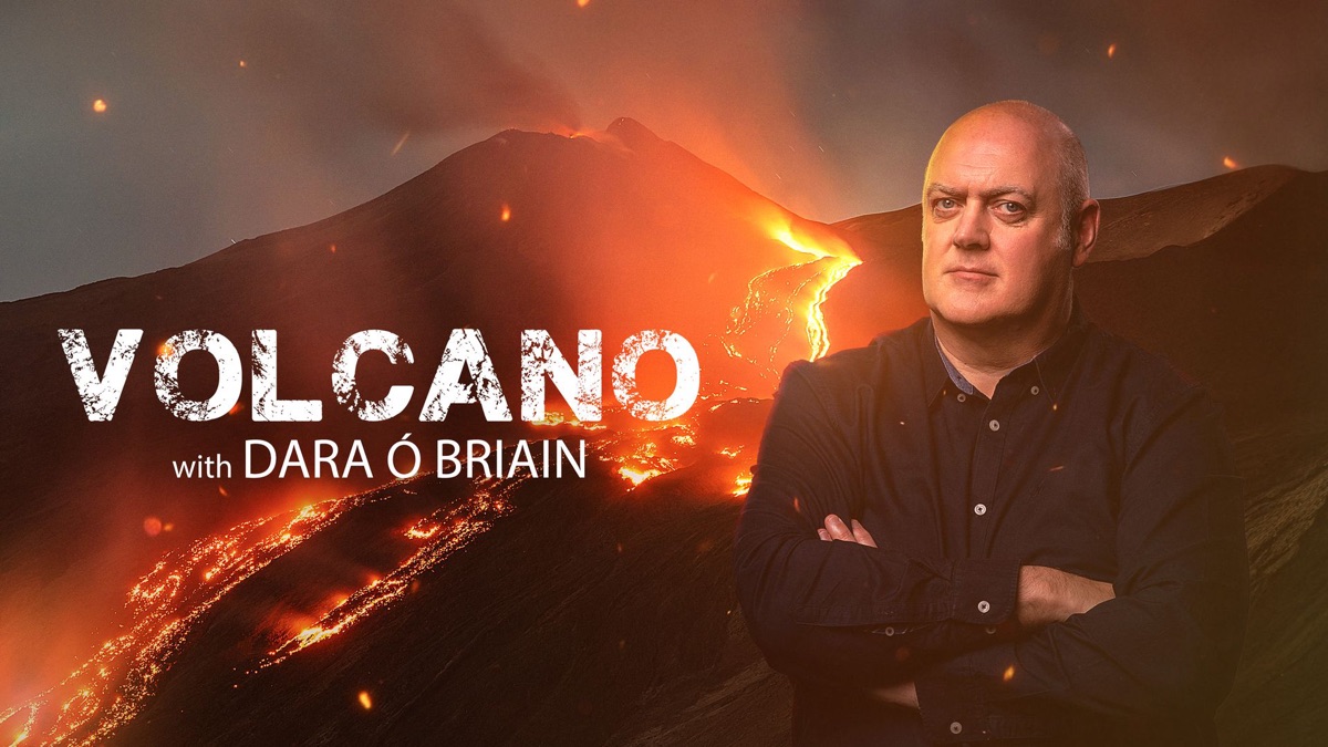 Dara Ó Briain standing in front of an erupting volcano
